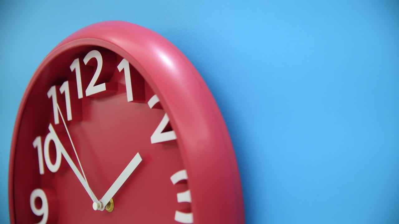 Red wall clock on blue background