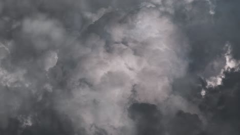 heavy thunderstorm in dark sky with black clouds