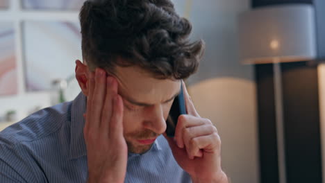 closeup angry entrepreneur arguing at phone call at office. businessman shouting