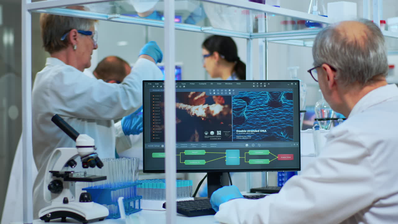 Scientist in lab coat working at a computer in laboratory