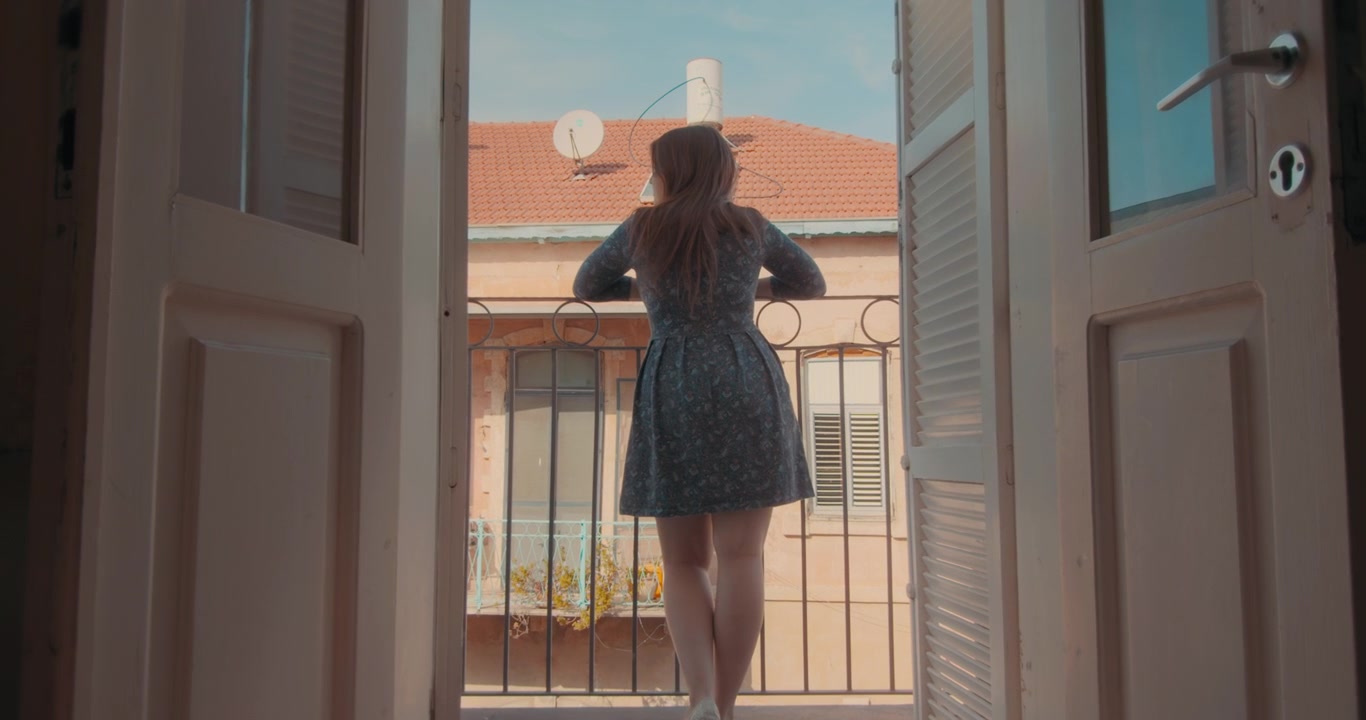 Frau genießt die Aussicht vom Balkon
