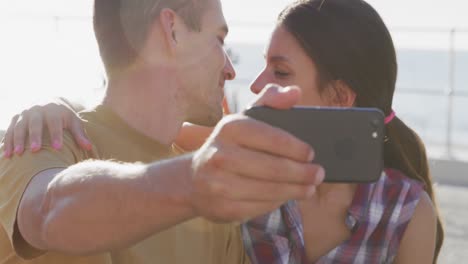 Young-adult-couple-relaxing-at-the-seaside