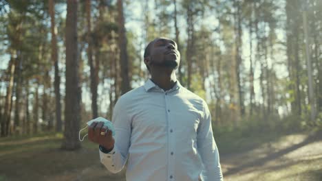 man wearing a mask in a forest