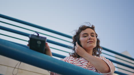 headphone woman moving tact rhythmic music at street close up. girl listening