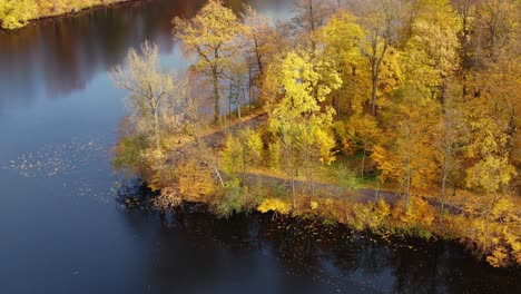 Aerial-view-of-beautiful-smooth-green-waters-of-a-lake-on-a-sunny-autumn-day