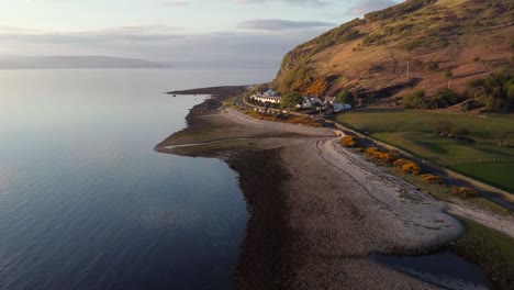 Aerial-view-of-the-Scottish-town-of-Catacol-on-the-Isle-of-Arran-at-sunset,-Scotland