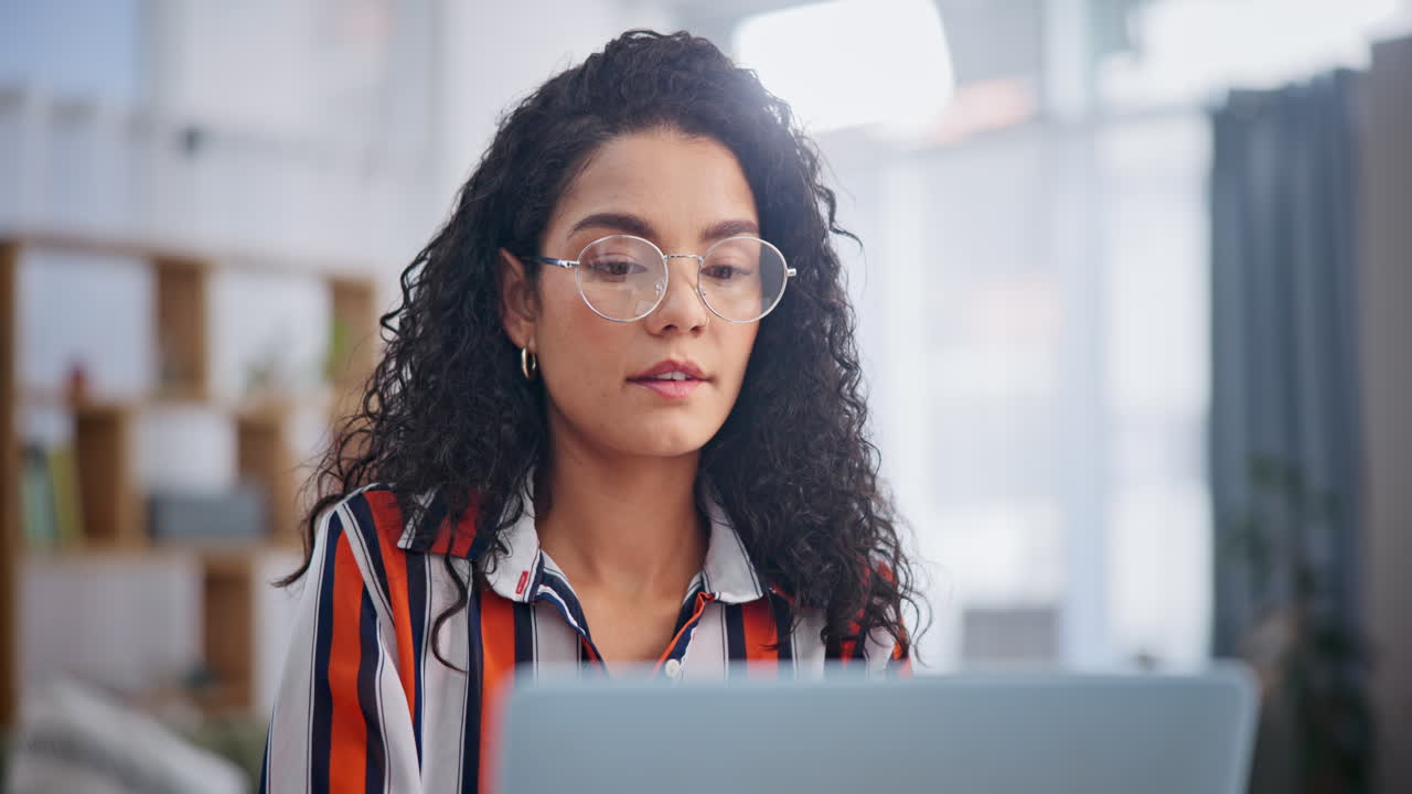 Woman Working on Laptop in Office