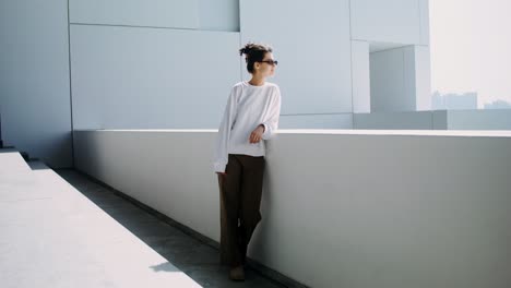 woman in trendy outfit by modern architecture