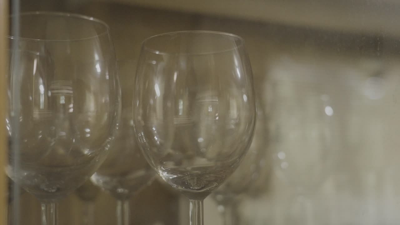 Various wine glasses in a cabinet, close up look
