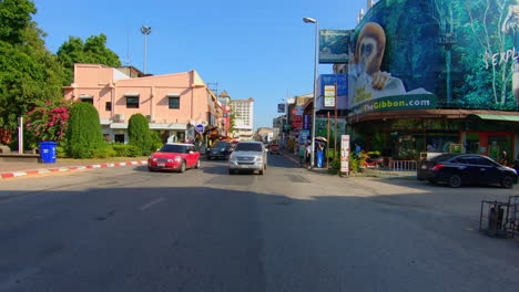 slow motion | pov car driving through a city in thailand