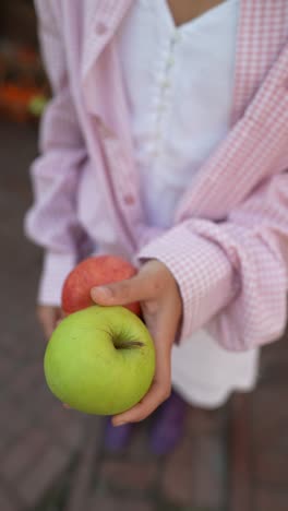 child holding apples