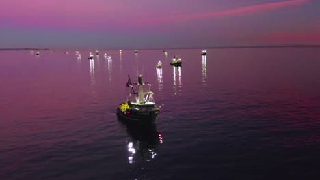 aerial of squid fishermen with fishing boats lit by bright spotlights off the coast of malibu california 2