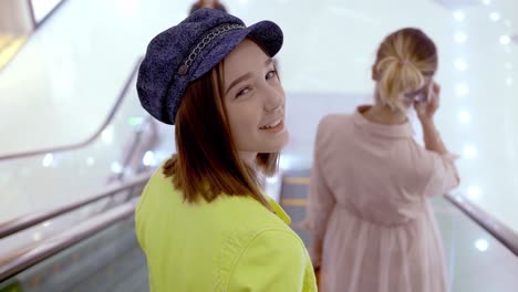 teenagers on escalator in shopping mall