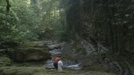 two people in a forest stream