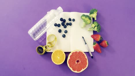 water bottle, fruits, vegetable, notebook, pen, and measuring tape