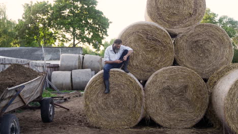 Man-sitting-on-haystack