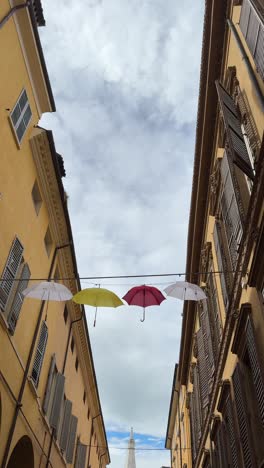 colorful umbrellas hanging in an italian alley