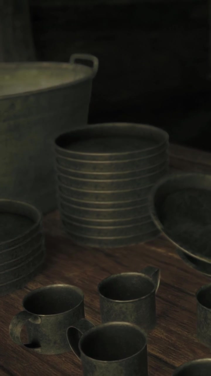 Metal dishes and cups arranged on a wooden table in a serving area