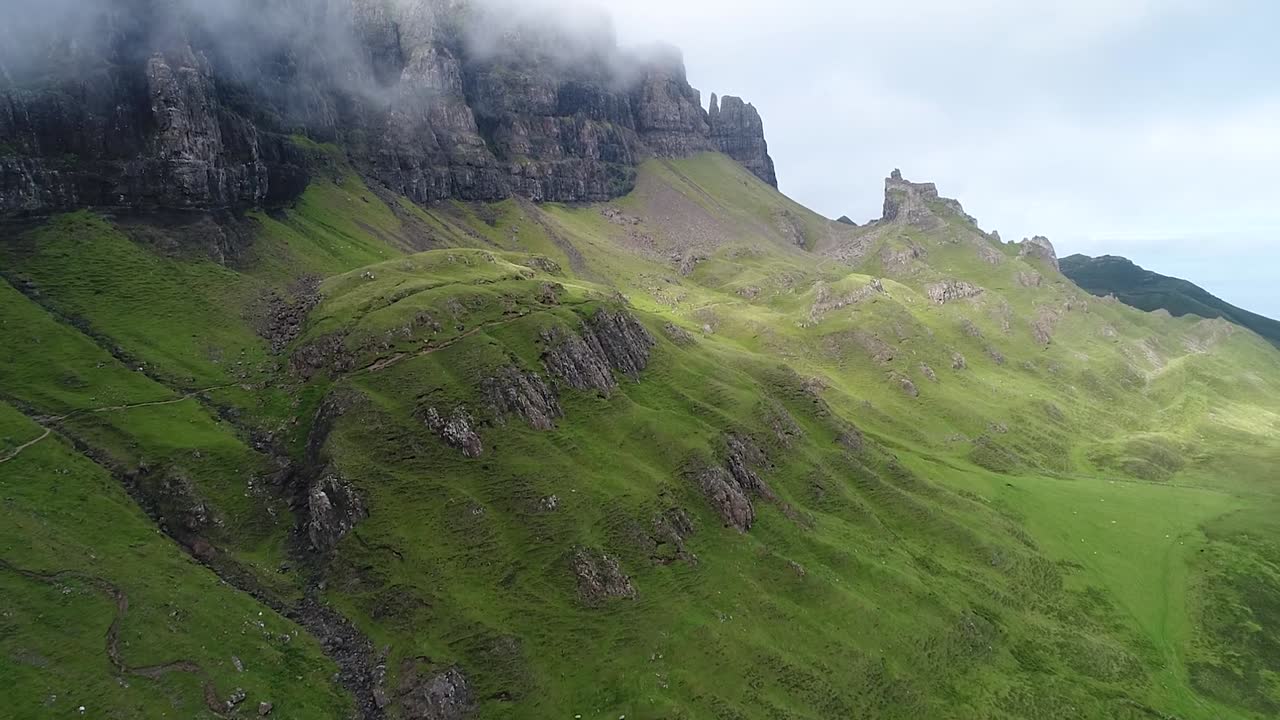 The quiraing is a famous landslip of the isle of skye in scotland, the volcanic area is green and rich in pinnacles and paths. This clip is recorded with a drone