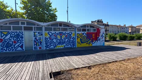 colorful graffiti art on buildings in pauillac