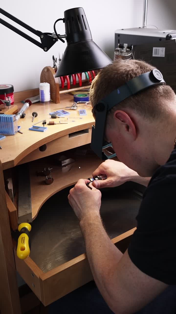 Man Jeweler Working on Detailed Craft at Workbench