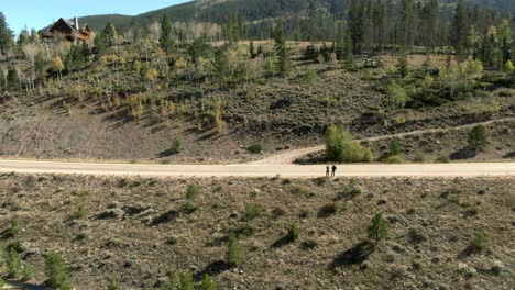 Aerial-dolly-forwards-to-road-and-hill-passing-people