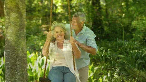 old couple playing on the swing