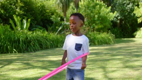 little boy playing with a hoop