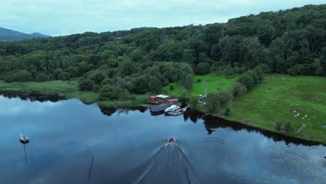 a speedboat approaches a houseboat homestead