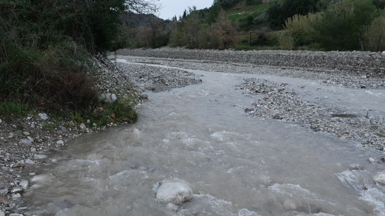 Flood is coming. Water flows. Pan right shot
