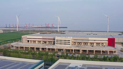 aerial shot of distribution warehouse with windmills in the background