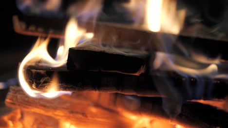 Super-close-up-footage-of-wood-burning-in-a-fire