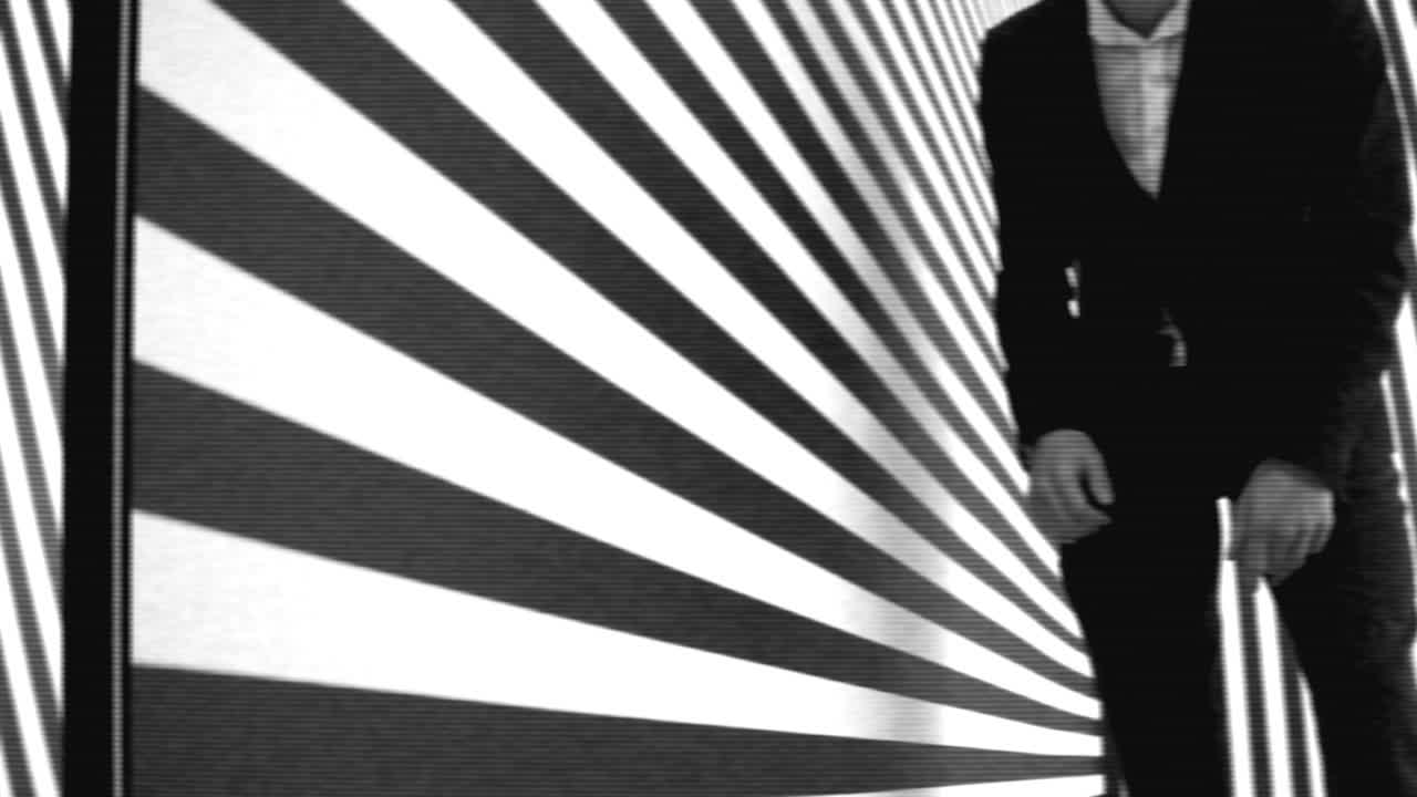 Black and White Man in a Suit with Abstract Pattern Background