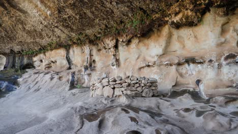 neolithic rock shelter under ancient overhanging sandstone wall