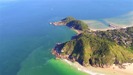 aerial view of pristine coastline of ilha do mel, paraná, brazil, lush green cliffs meet crystal-clear turquoise waters