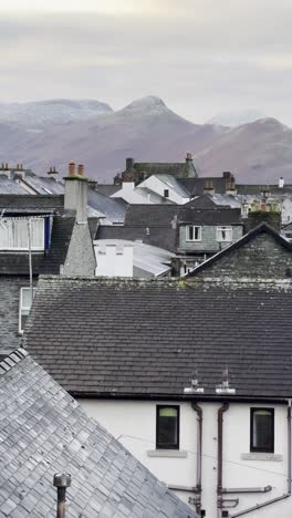iconic peak of catbells towering over slate rooftops of keswick on a winter's morning - lake district, uk [portrait video]