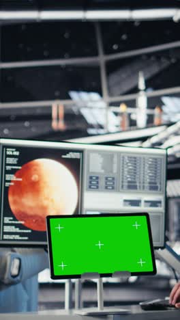 vertical video astronauts in advanced technology spacecraft using green screen monitor