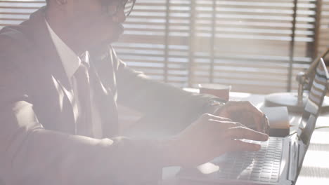 Black-Businessman-Typing-on-Laptop-in-Office