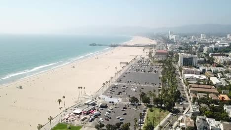 sandy los angeles beachfront coastline aerial view reverse dolly right above downtown property