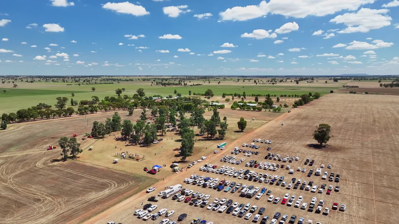Over carpark in a paddock at a vintage harvester display at Pleasant Hills NSW Australia