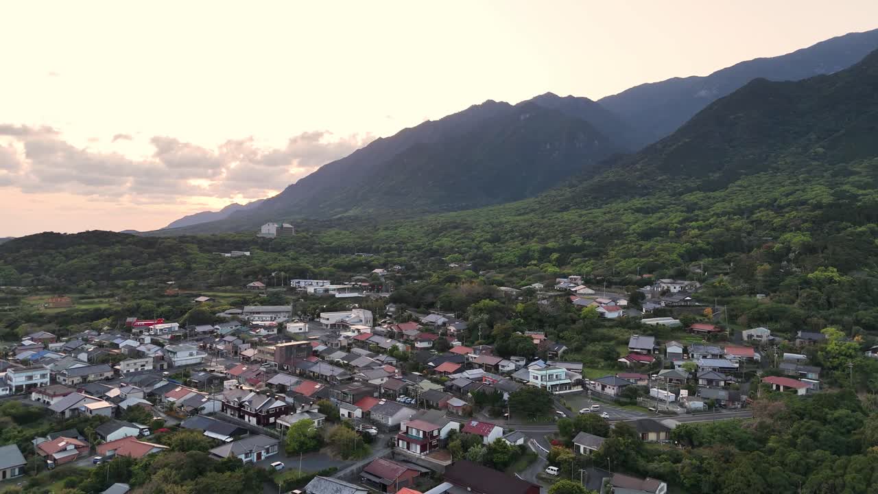 Aerial View of a Village Surrounded by Mountains and Trees