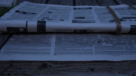 newspapers tied to wooden plank