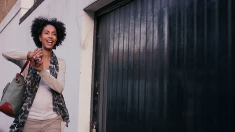 Beautiful-Mixed-race-woman-using-smart-watch-technology-walking-through-city