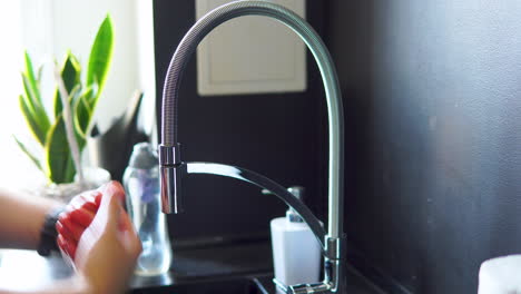 person turns on faucet and wash hands in the sink