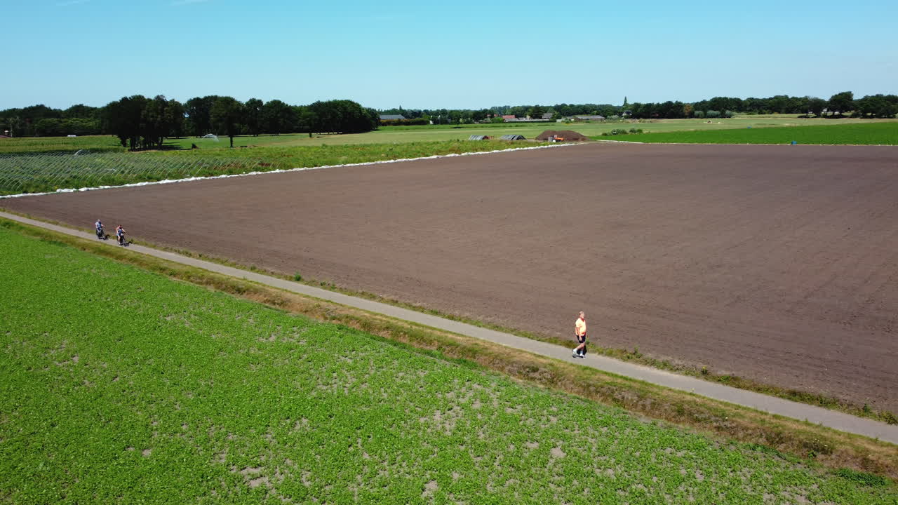 Cyclists in a Dutch Countryside Field