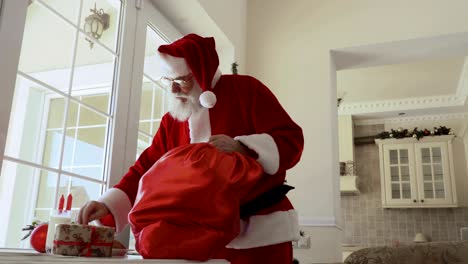 santa takes the treats from the table and taste it