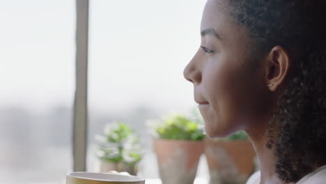 beautiful woman drinking coffee at home looking out window relaxing happy african american female enjoying relaxed lifestyle close up