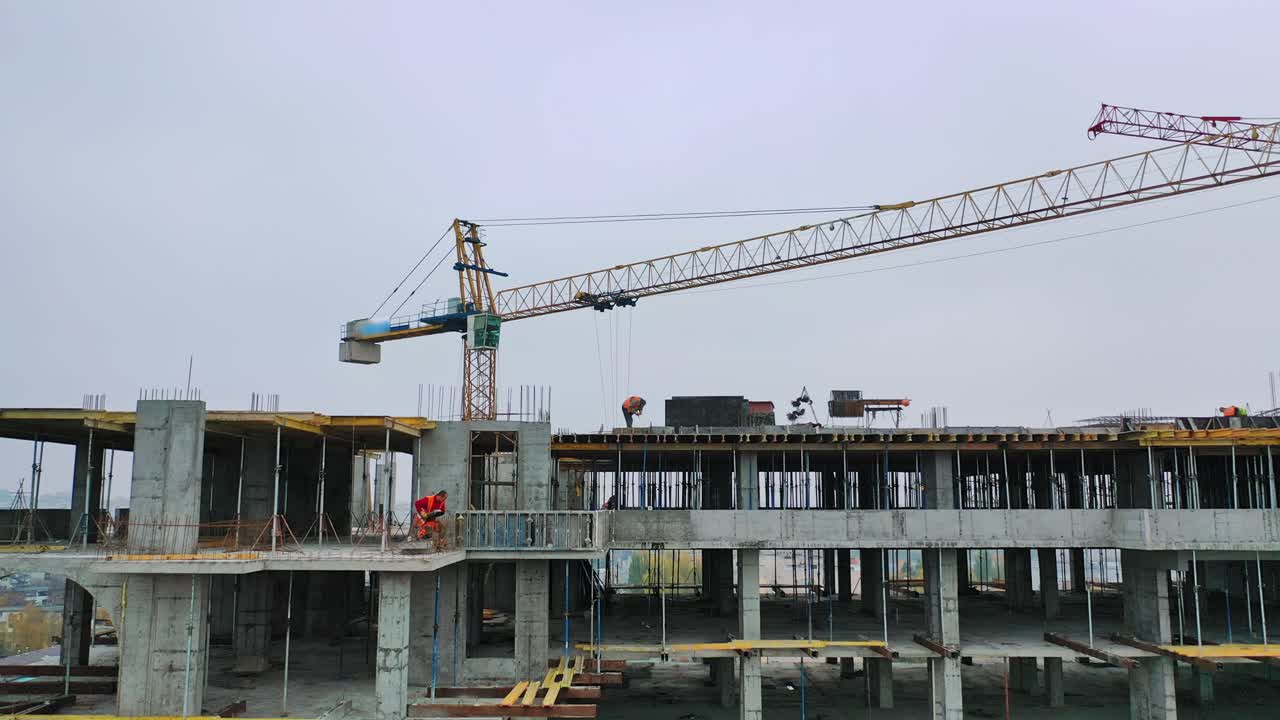 Flying over the construction site. Construction crane on building background