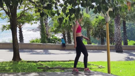 mujer caminando en un parque tropical con vista al océano