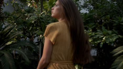 Young-girl-model-running-in-tropical-greenhouse